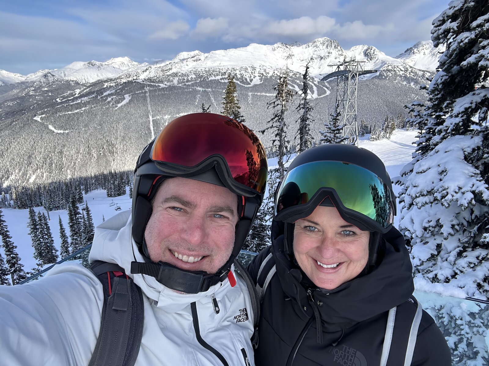 Jackson and Deanna Loychuk in helmets and goggles on a snowy Whistler run